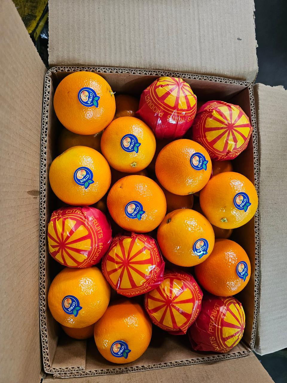 Open box of oranges